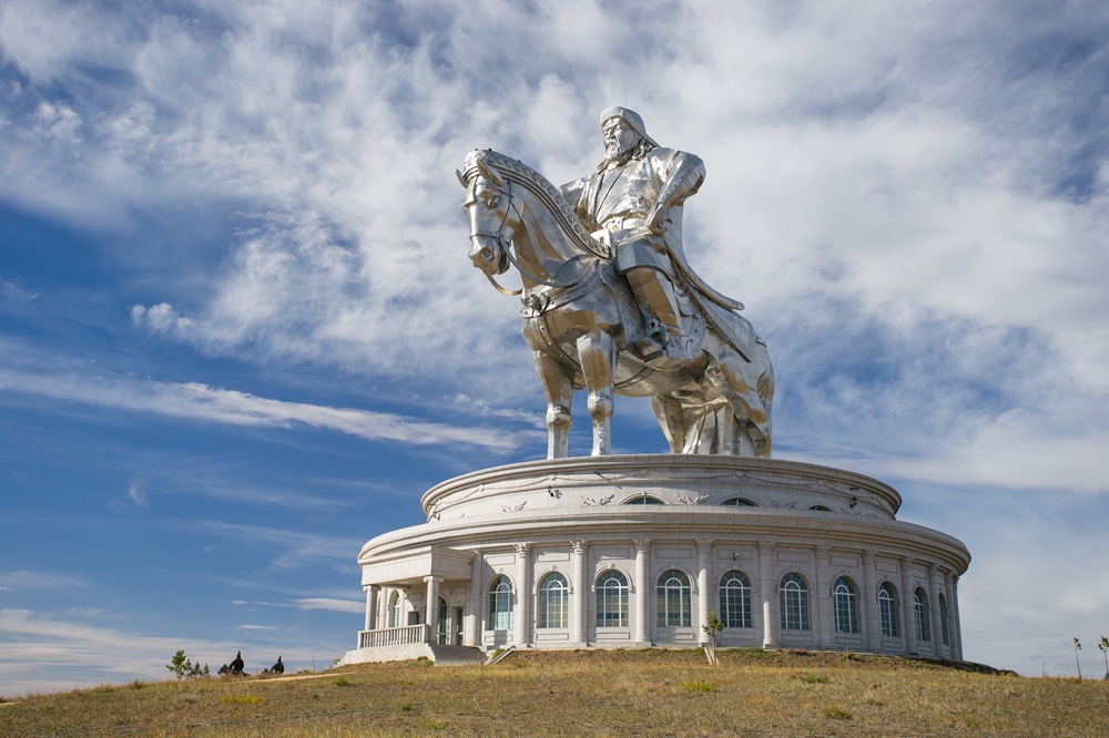 The massive 40-meter high silver equestrian statue of Genghis Khan standing on a circular visitor center building.